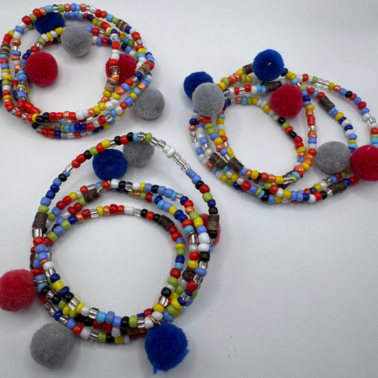 Colorful beaded bracelets with pom-poms